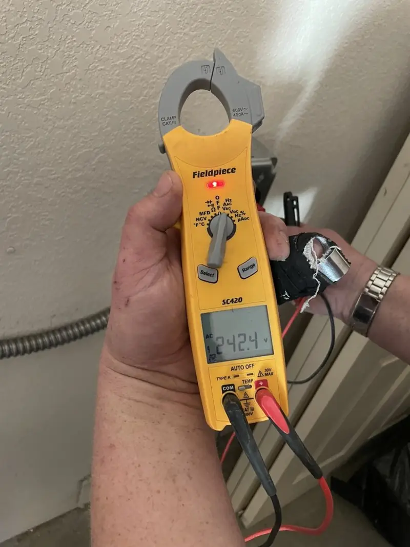 Voltage testing with clamp meter during Outlet Installation in Livingston